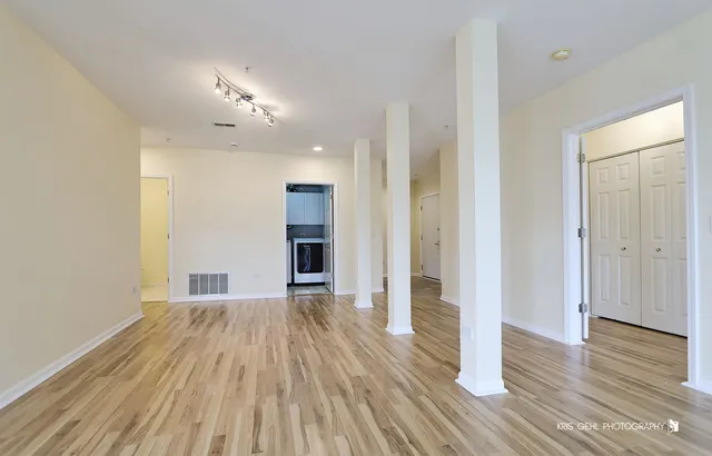 a kitchen with granite countertop stainless steel appliances white cabinets sink and dishwasher