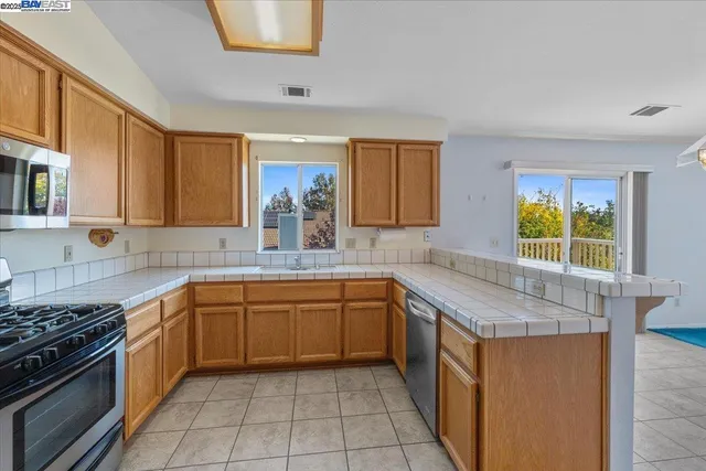 a kitchen with a sink stove and cabinets