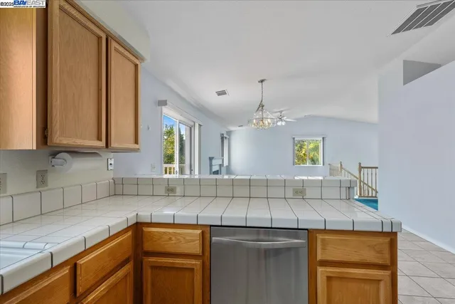 a kitchen with a sink a stove cabinets and counter space