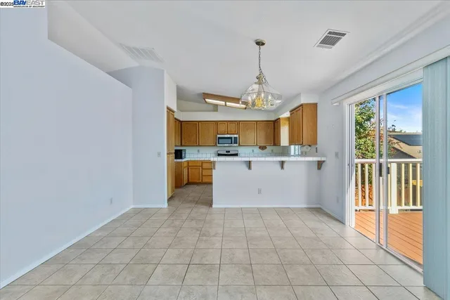 a view of a kitchen with a sink and windows