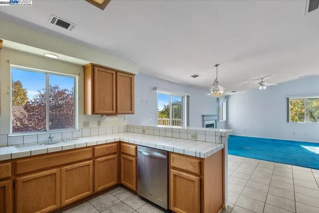 a kitchen with stainless steel appliances granite countertop a sink and a granite counter tops