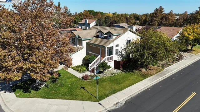 an aerial view of a house with a garden and trees