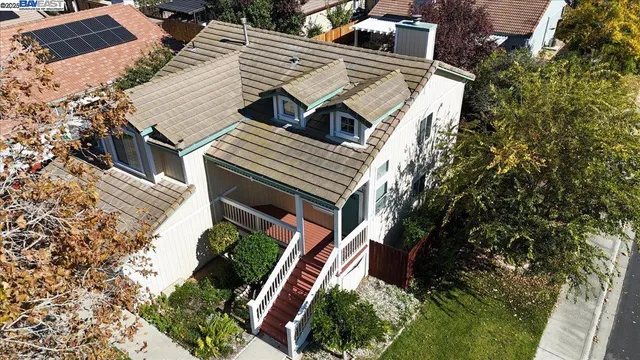 an aerial view of a house with a yard and potted plants