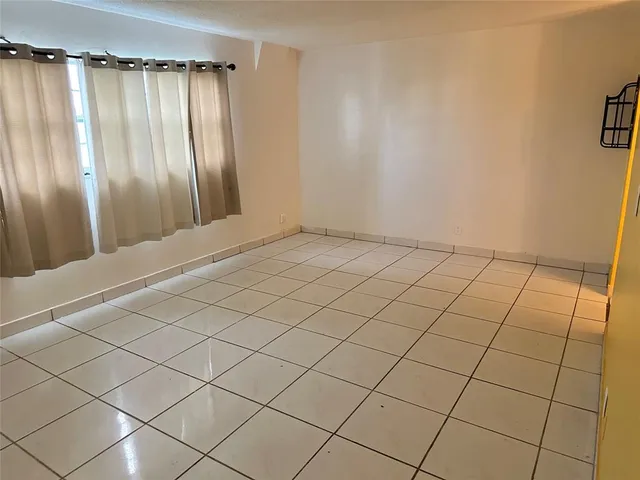 a view of an empty room and a window