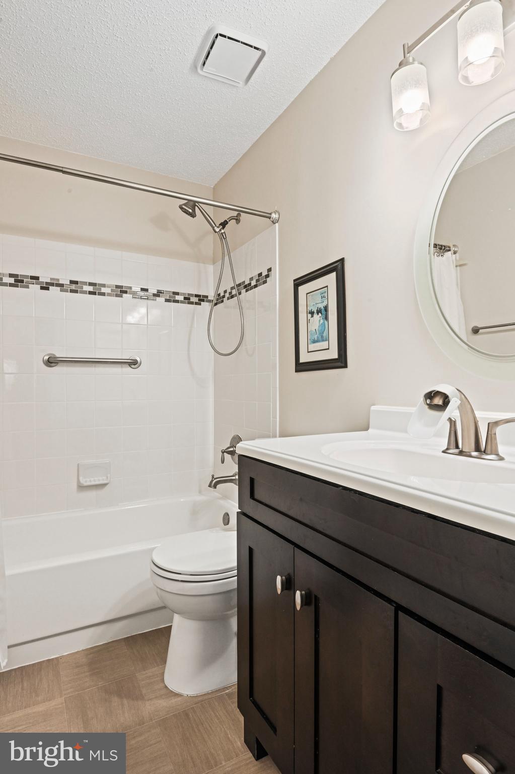 21013 Timber Ridge Terrace, Unit 202 Ashburn, VA 20147 - Photo 16 of 42 a bathroom with a sink a toilet and a mirror