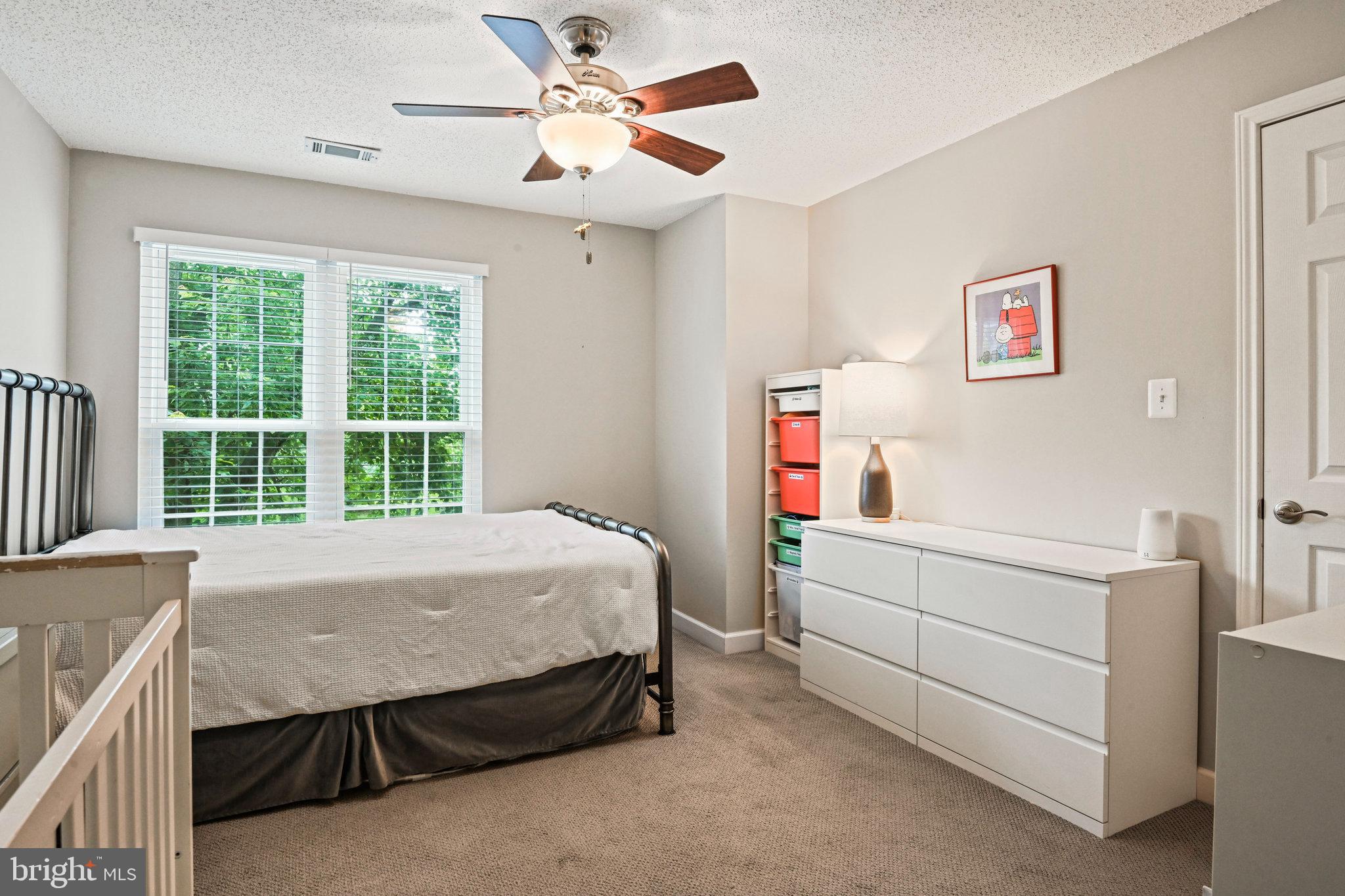 21013 Timber Ridge Terrace, Unit 202 Ashburn, VA 20147 - Photo 18 of 42 a bed room with a bed and a window