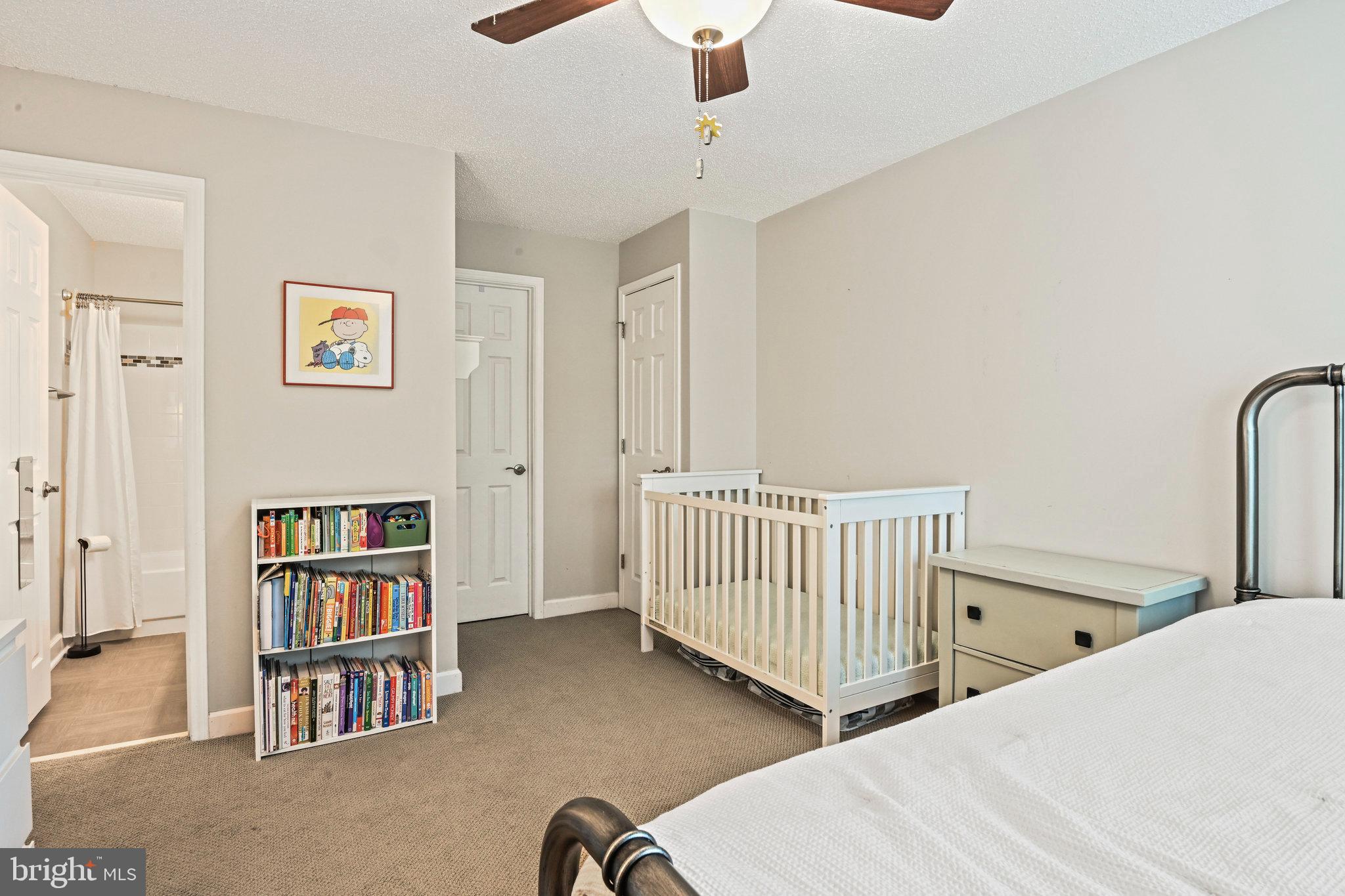 21013 Timber Ridge Terrace, Unit 202 Ashburn, VA 20147 - Photo 19 of 42 a bedroom with furniture and a book shelf