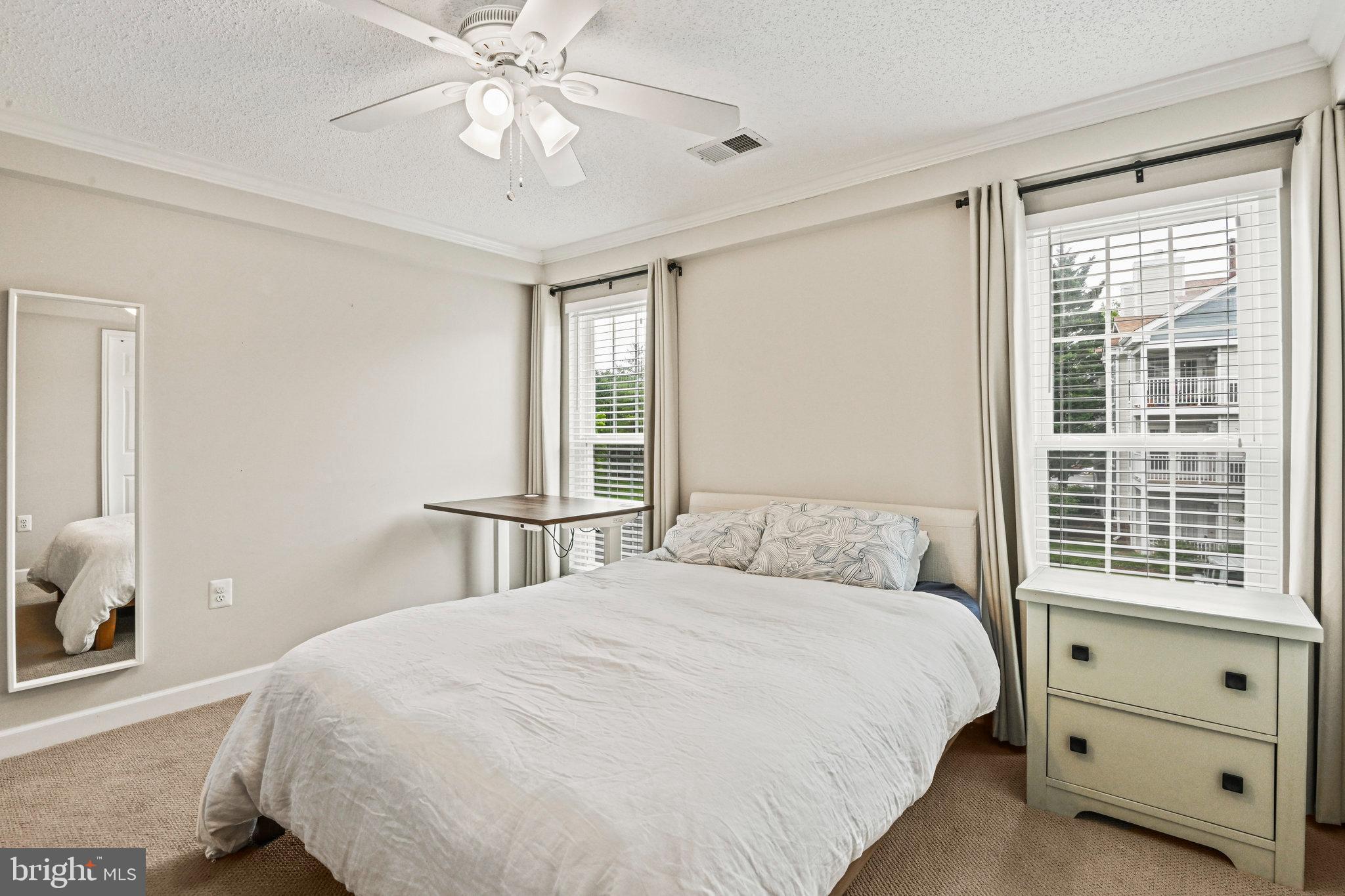21013 Timber Ridge Terrace, Unit 202 Ashburn, VA 20147 - Photo 21 of 42 a bedroom with a bed and a window