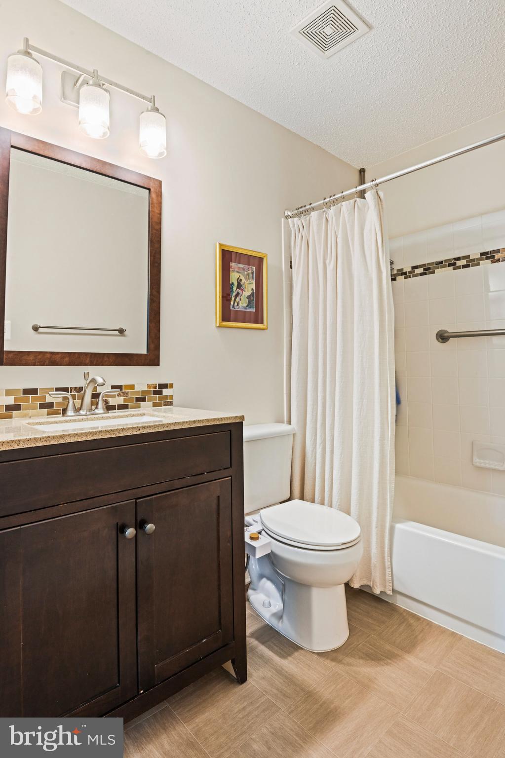 21013 Timber Ridge Terrace, Unit 202 Ashburn, VA 20147 - Photo 24 of 42 a bathroom with a sink toilet and shower
