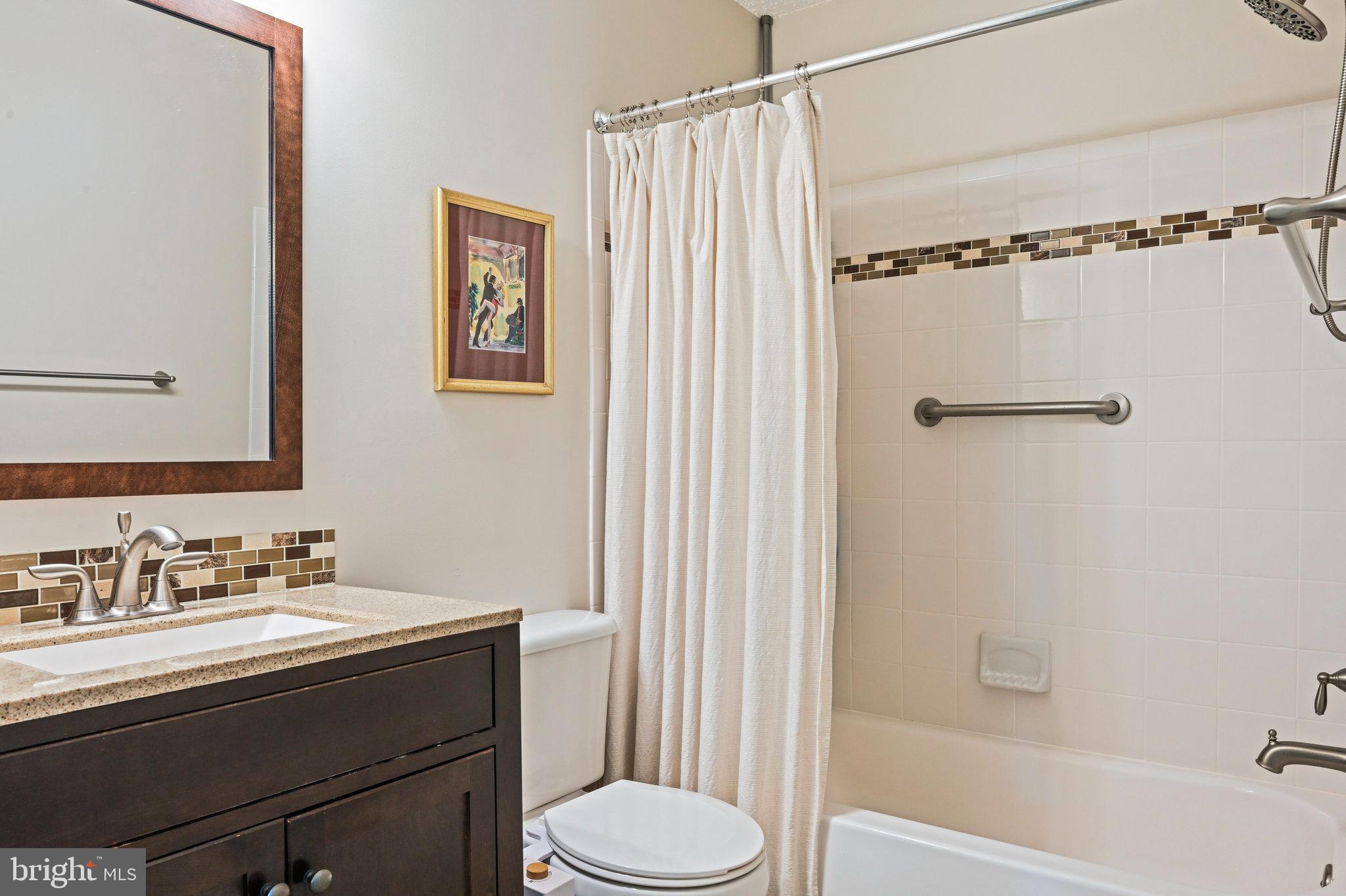 21013 Timber Ridge Terrace, Unit 202 Ashburn, VA 20147 - Photo 25 of 42 a bathroom with a sink toilet and shower