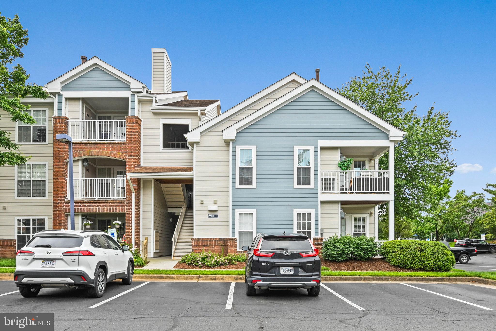 21013 Timber Ridge Terrace, Unit 202 Ashburn, VA 20147 - Photo 27 of 42 a car parked in front of a house