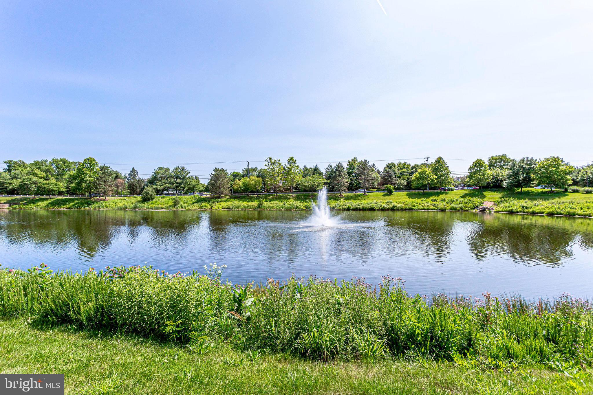 21013 Timber Ridge Terrace, Unit 202 Ashburn, VA 20147 - Photo 33 of 42 a view of a lake with houses in the back