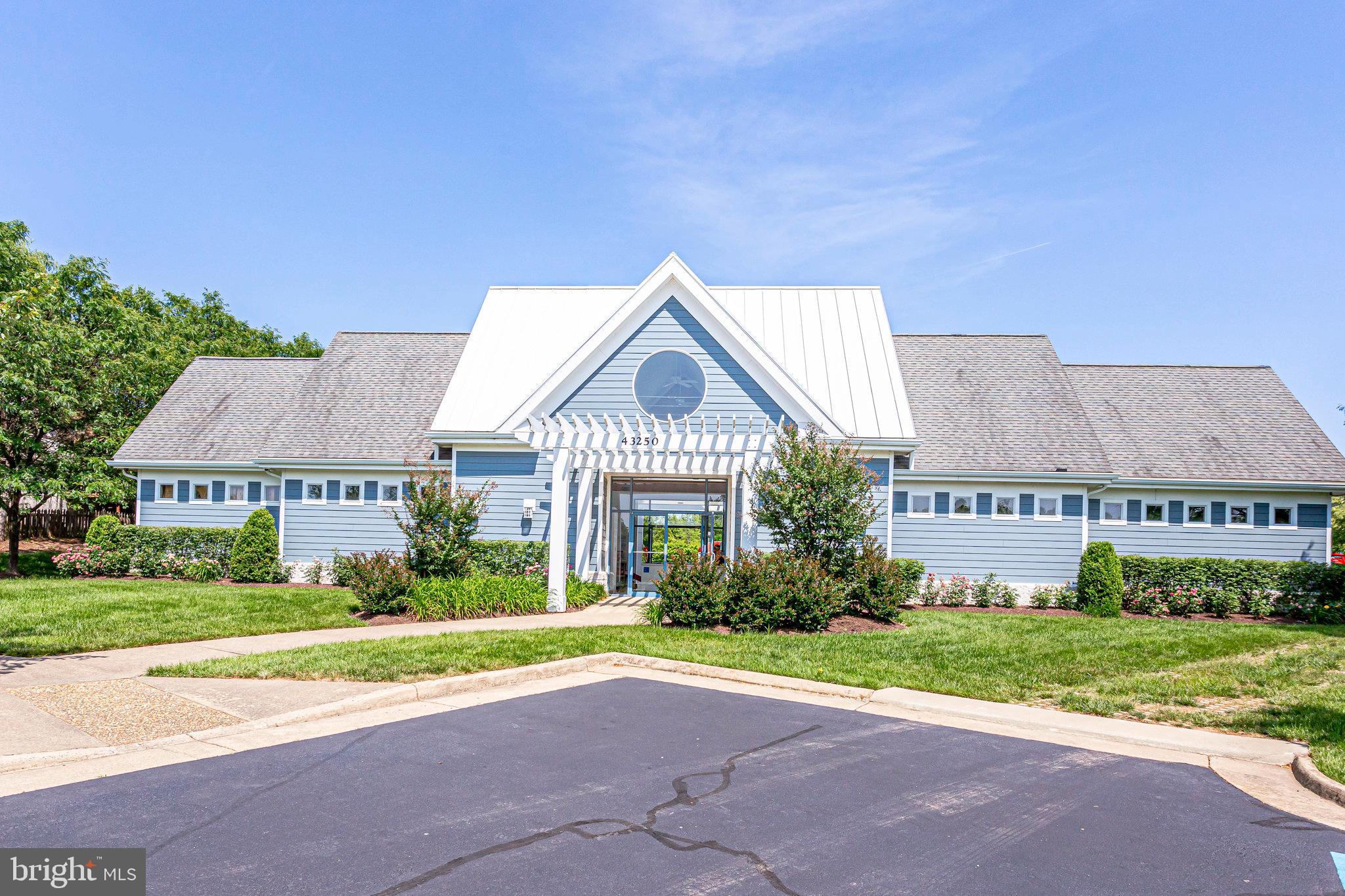 21013 Timber Ridge Terrace, Unit 202 Ashburn, VA 20147 - Photo 40 of 42 a view of house with yard and street view