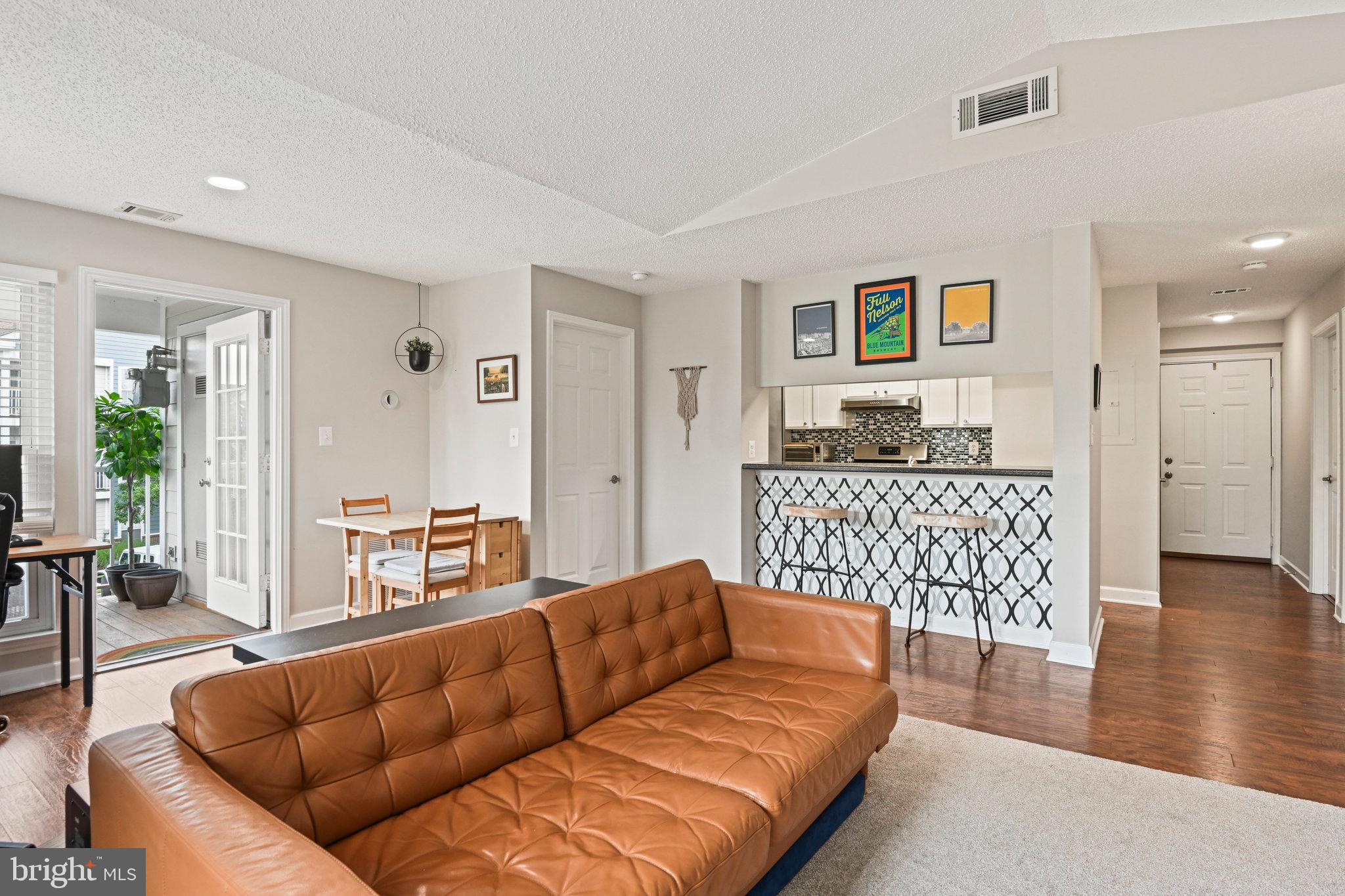 21013 Timber Ridge Terrace, Unit 202 Ashburn, VA 20147 - Photo 10 of 42 a living room with furniture