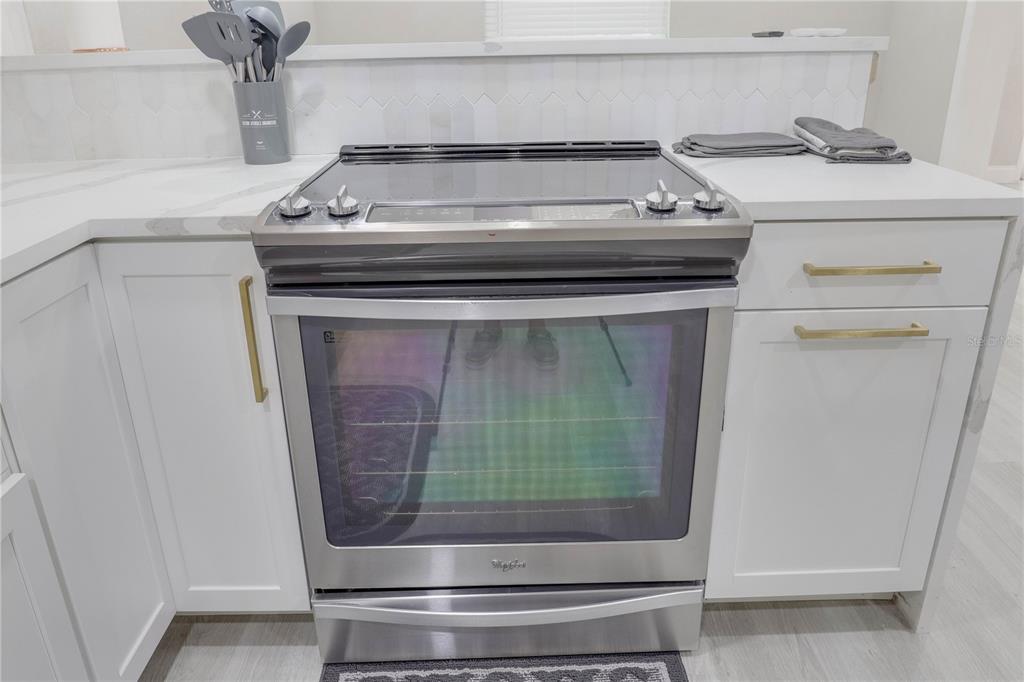 110 Duval Road Winter Haven, FL 33884 - Photo 12 of 25 a stove top oven sitting inside of a kitchen