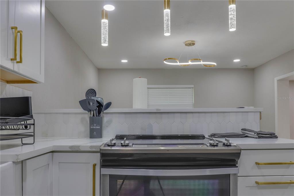 110 Duval Road Winter Haven, FL 33884 - Photo 17 of 25 a stove top oven sitting inside of a kitchen