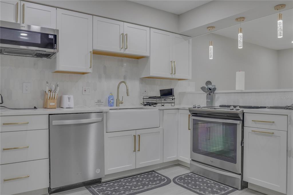 110 Duval Road Winter Haven, FL 33884 - Photo 18 of 25 a kitchen with white cabinets and appliances