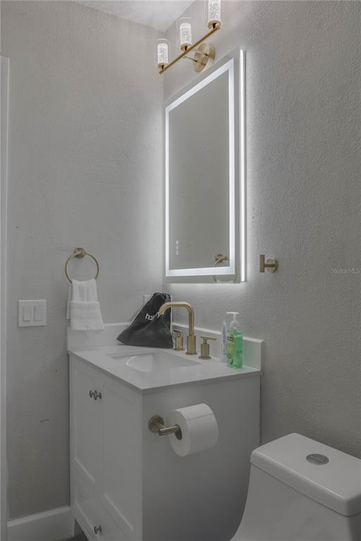 110 Duval Road Winter Haven, FL 33884 - Photo 19 of 25 a bathroom with a toilet sink and mirror