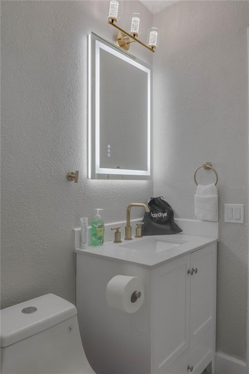 110 Duval Road Winter Haven, FL 33884 - Photo 21 of 25 a bathroom with a sink a toilet and mirror