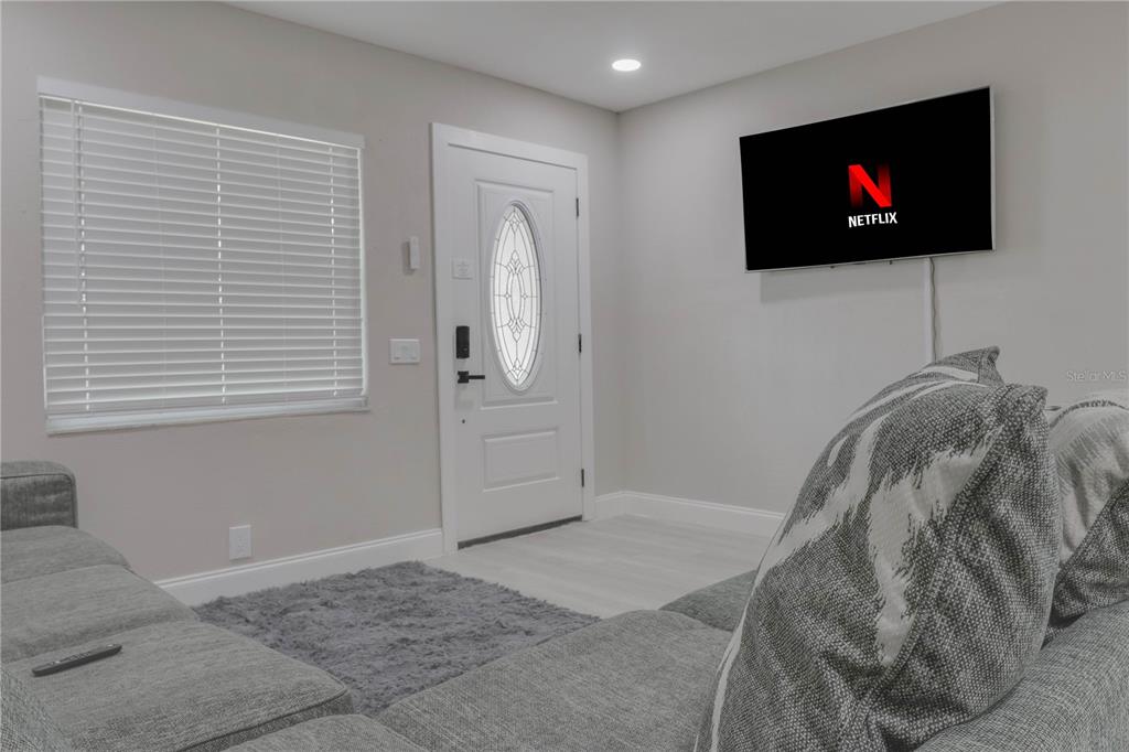 110 Duval Road Winter Haven, FL 33884 - Photo 4 of 25 a living room with a flat screen tv and a window