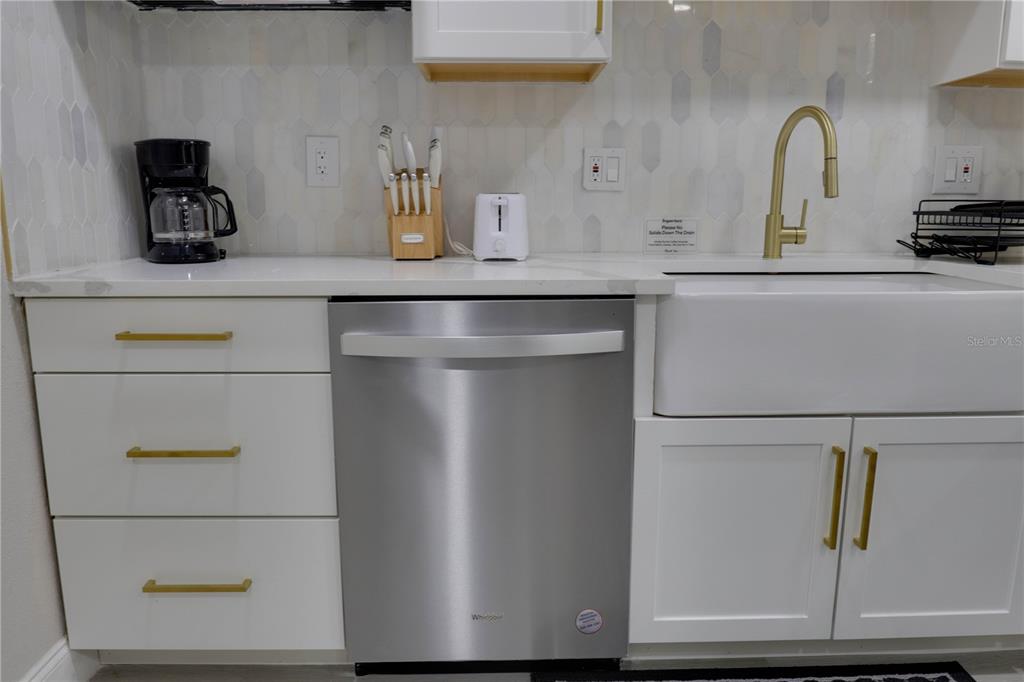 110 Duval Road Winter Haven, FL 33884 - Photo 10 of 25 a kitchen with a refrigerator and cabinets