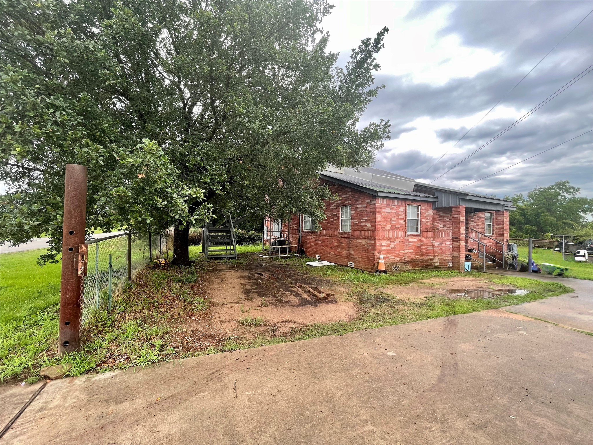 20661 Cochran Road Prairie View, TX 77445 - Photo 2 of 8 a view of a house with a yard and large trees