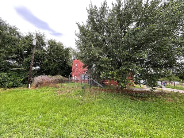a backyard of a house with a yard and outdoor seating