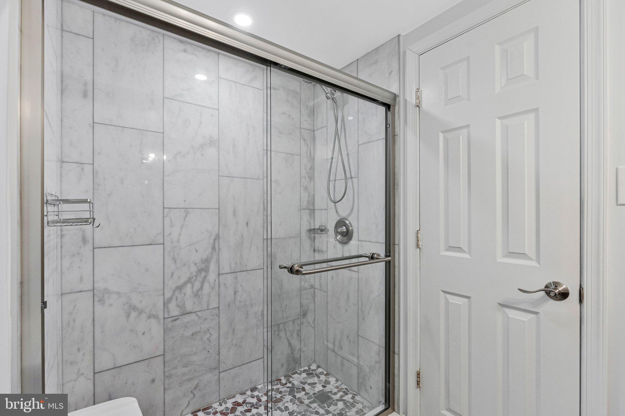 2012 Colts Neck Road, Unit 21A Reston, VA 20191 - Photo 24 of 44 Sleek marble shower oasis awaits you.