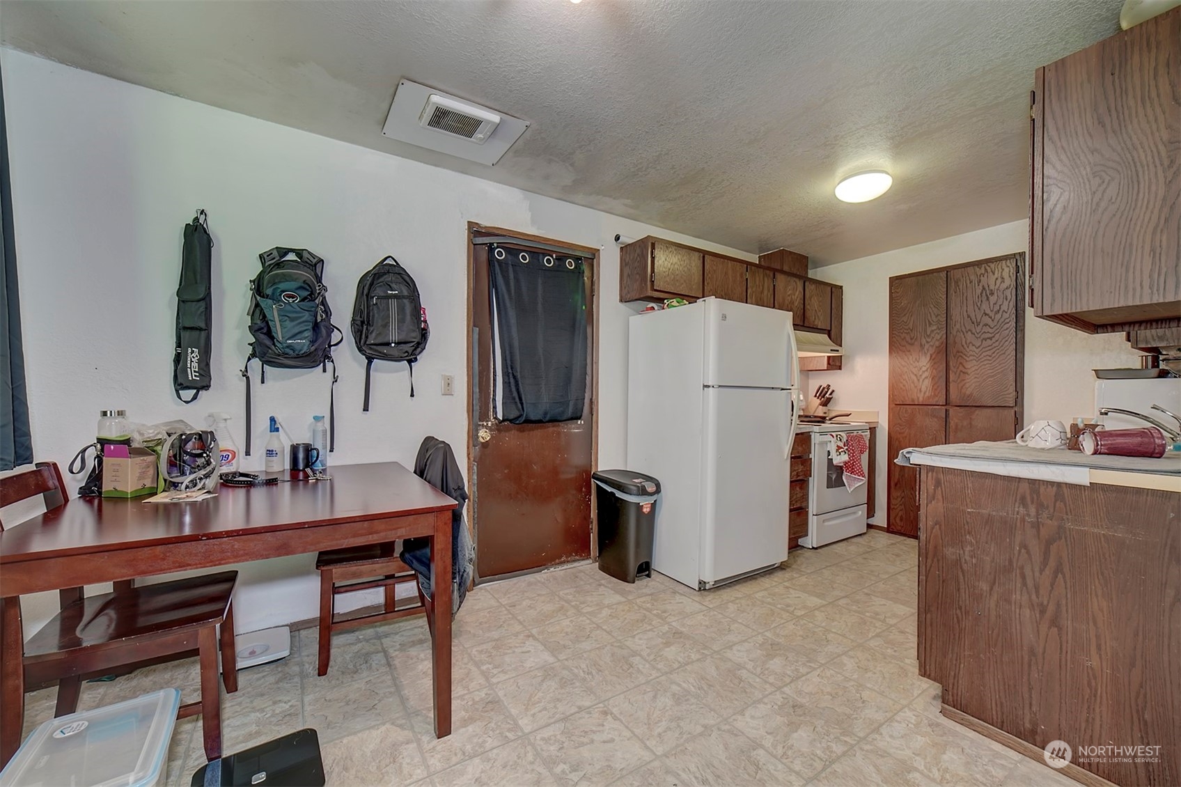 7615 Illahee Road Northeast Bremerton, WA 98311 - Photo 17 of 23 a kitchen with refrigerator and cabinets