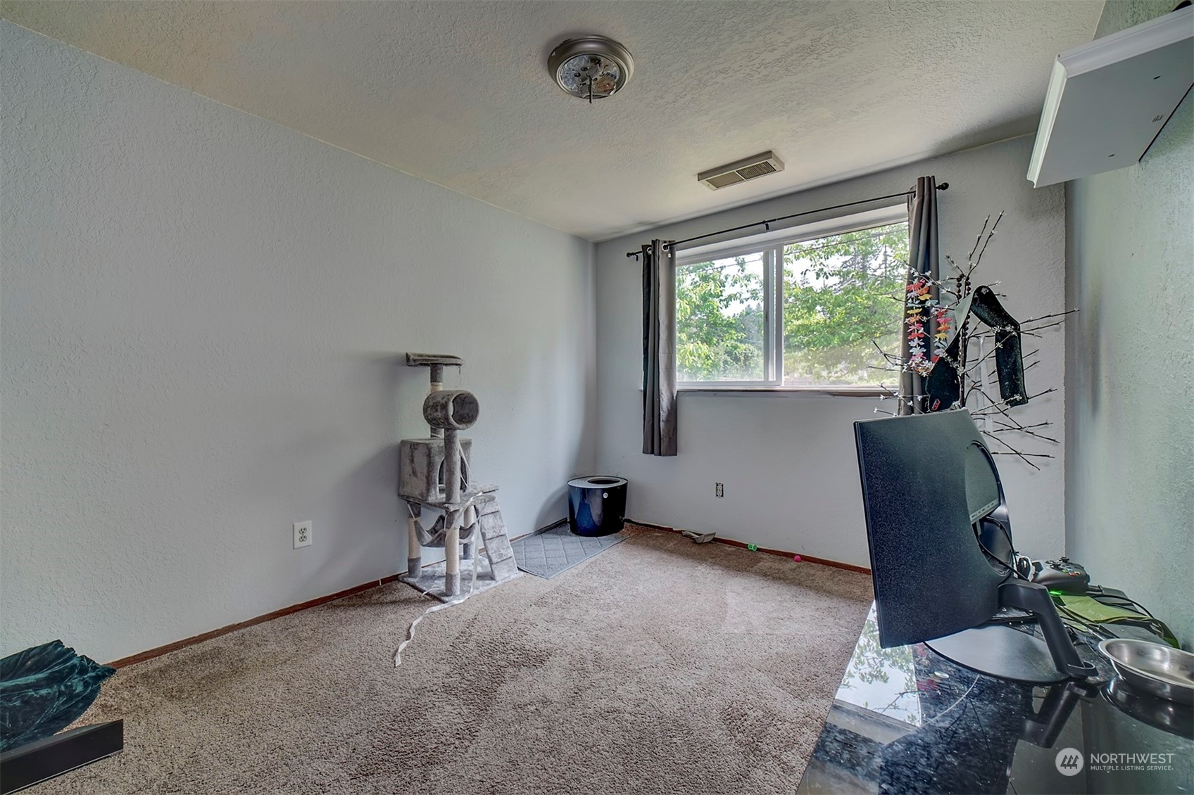 7615 Illahee Road Northeast Bremerton, WA 98311 - Photo 19 of 23 a view of a room with gym equipment and windows