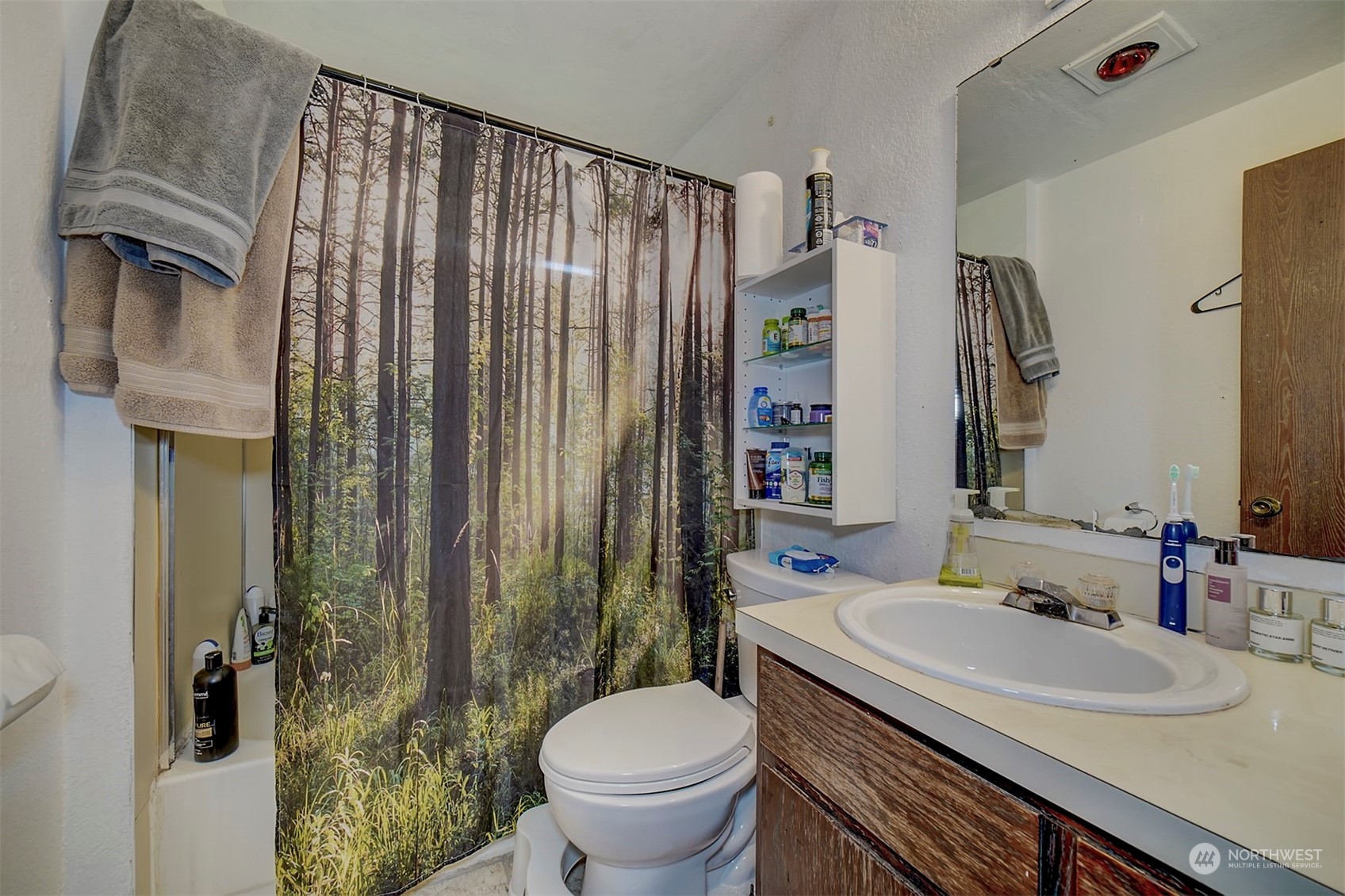 7615 Illahee Road Northeast Bremerton, WA 98311 - Photo 20 of 23 a bathroom with a sink toilet and shower