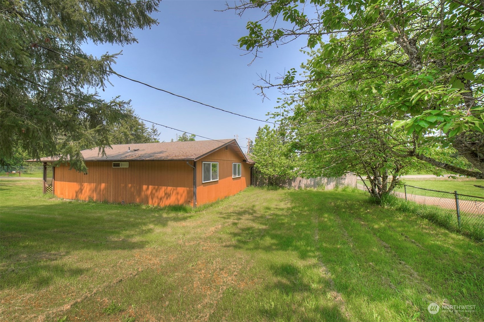 7615 Illahee Road Northeast Bremerton, WA 98311 - Photo 21 of 23 a view of a tree in front of a house with a yard