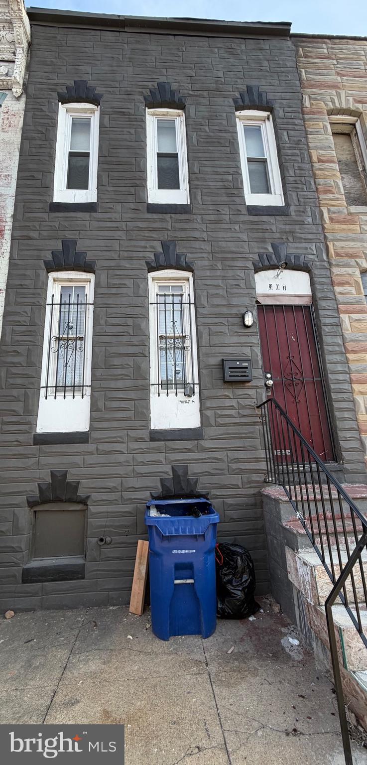 a view of a brick house with many windows