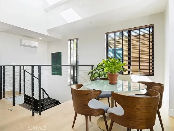 a dining room with furniture and floor to ceiling windows