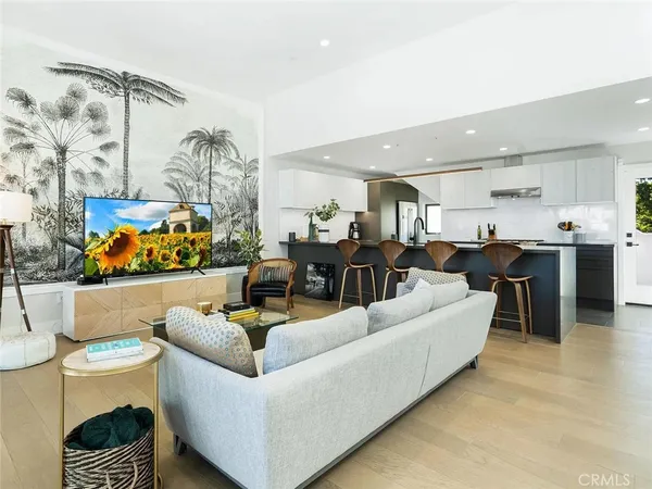 a living room with furniture kitchen view and a table