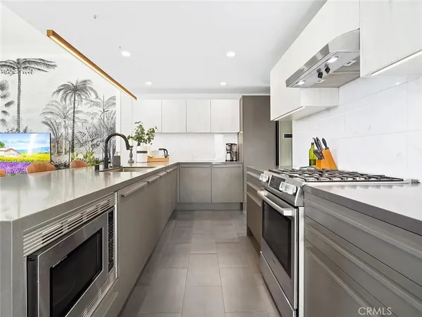 a kitchen with stainless steel appliances granite countertop a stove and a sink