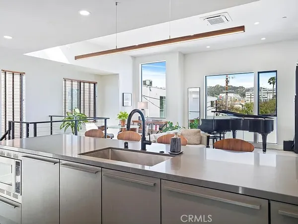 a kitchen with a sink and a large window