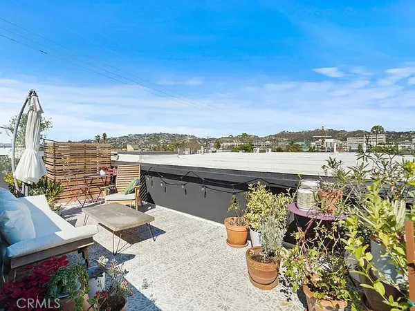 a view of a terrace with wooden floor and city view