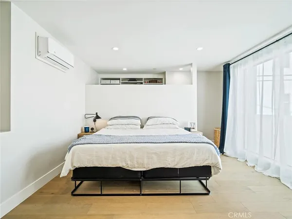 a bedroom with a bed and window