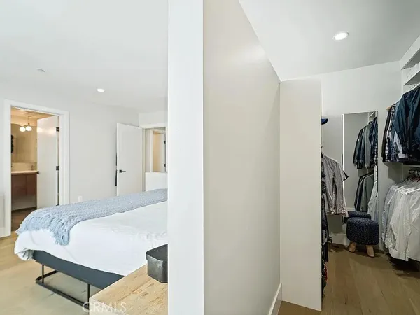 a bedroom with a bed and a view in closet