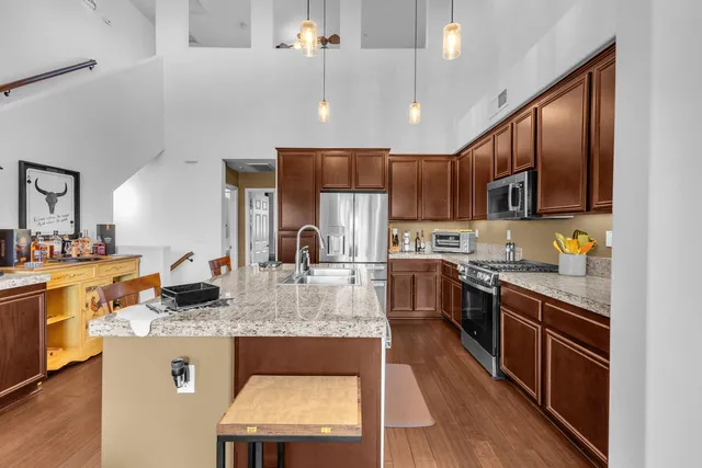 a kitchen with a stove a refrigerator and a table