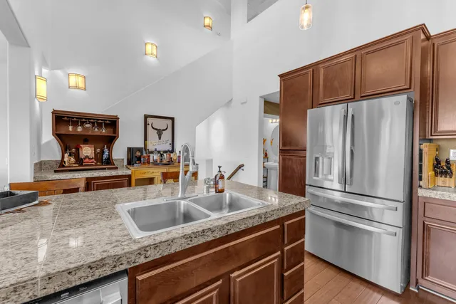 a kitchen with stainless steel appliances granite countertop a stove microwave and cabinets