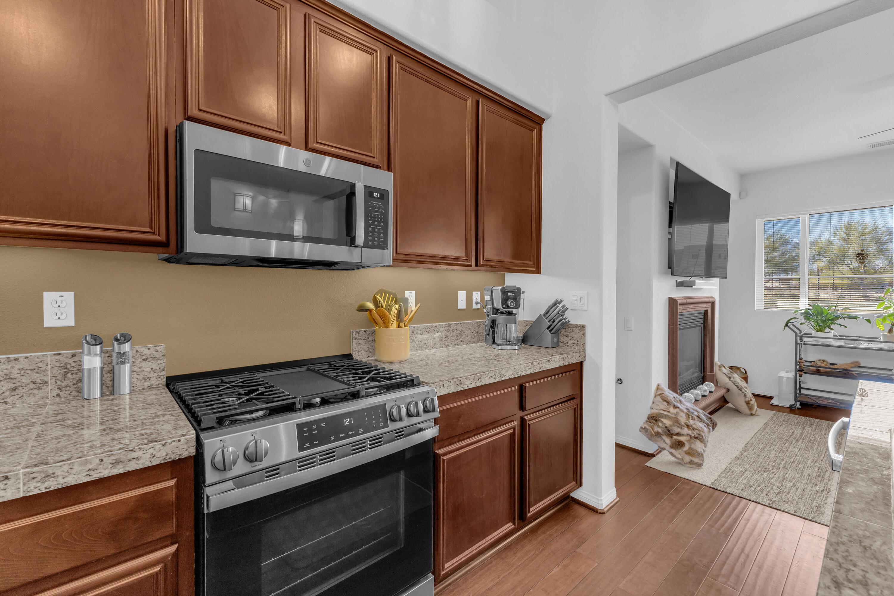73268 Azure Rain, Unit 102 Palm Desert, CA 92211 - Photo 18 of 44 a kitchen with stainless steel appliances granite countertop a stove microwave and cabinets
