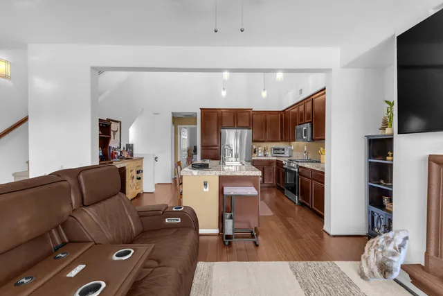a living room with furniture a flat screen tv and a fireplace