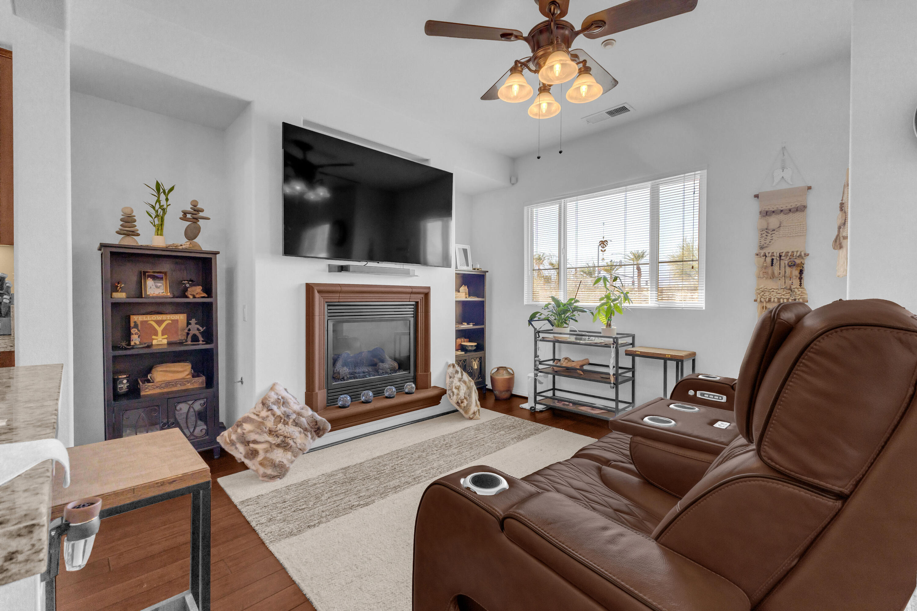 73268 Azure Rain, Unit 102 Palm Desert, CA 92211 - Photo 20 of 44 a living room with furniture a flat screen tv and a fireplace