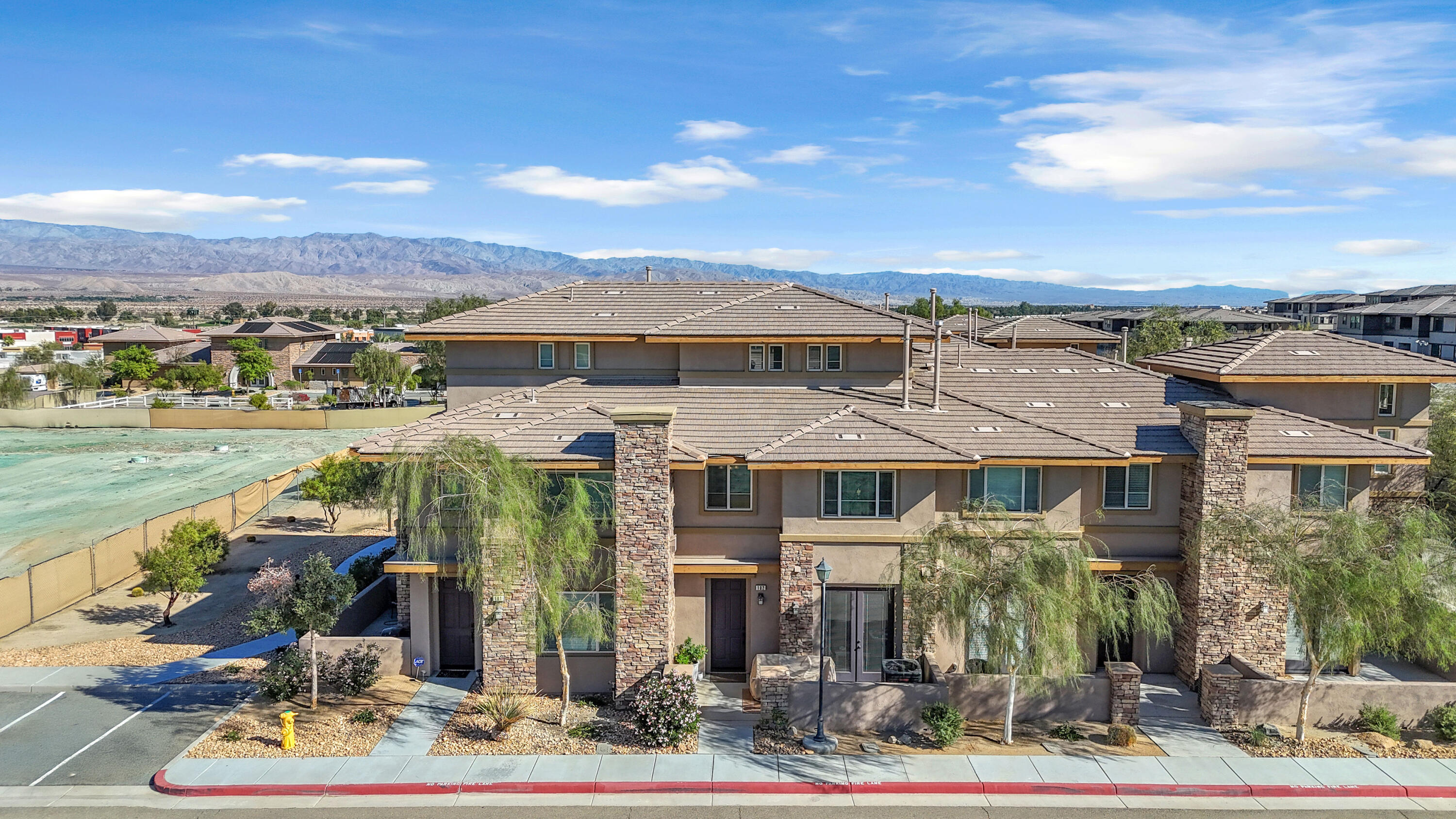 73268 Azure Rain, Unit 102 Palm Desert, CA 92211 - Photo 38 of 44 a front view of a house with garden