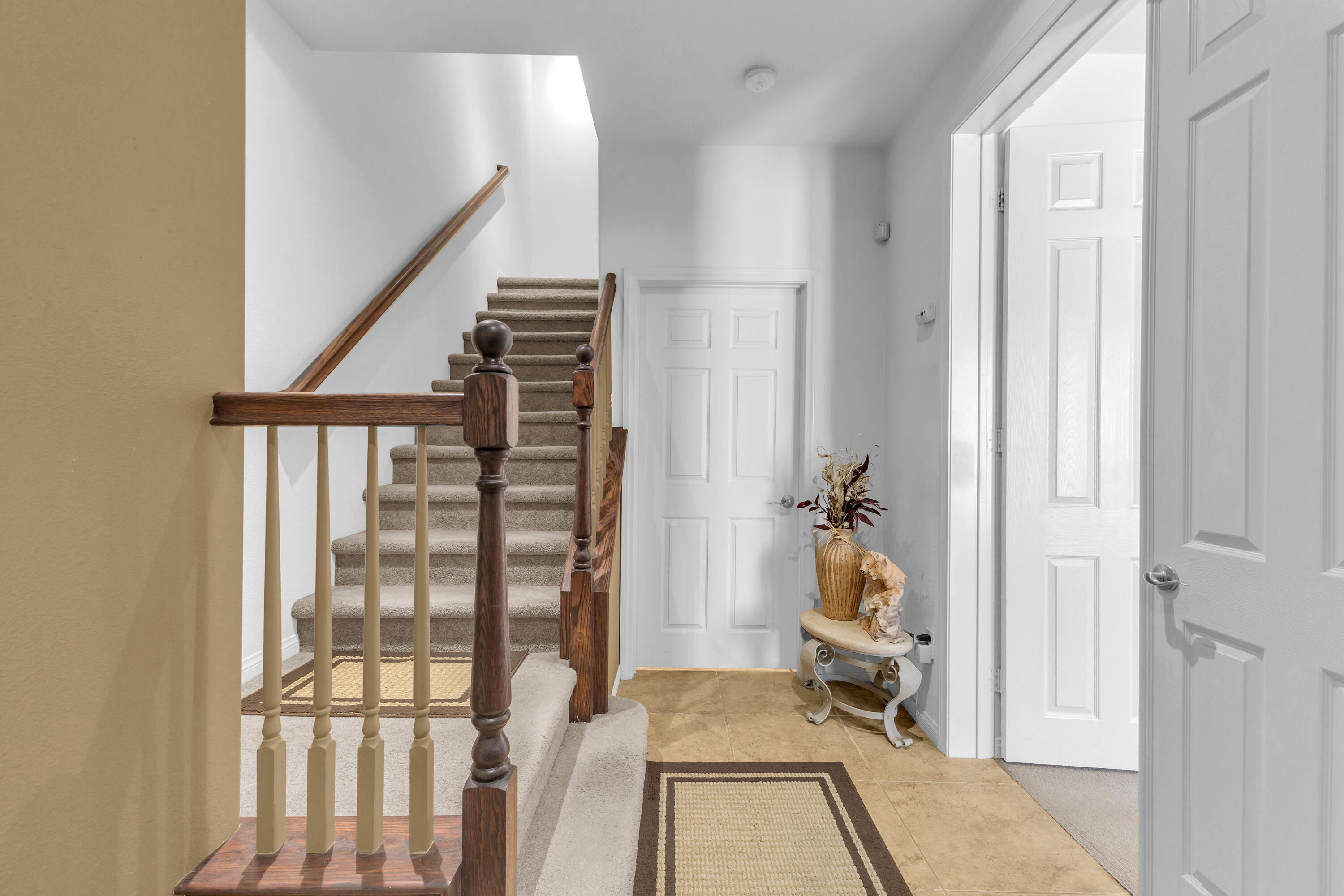 73268 Azure Rain, Unit 102 Palm Desert, CA 92211 - Photo 4 of 44 a view of a bedroom with wooden floor and stairs