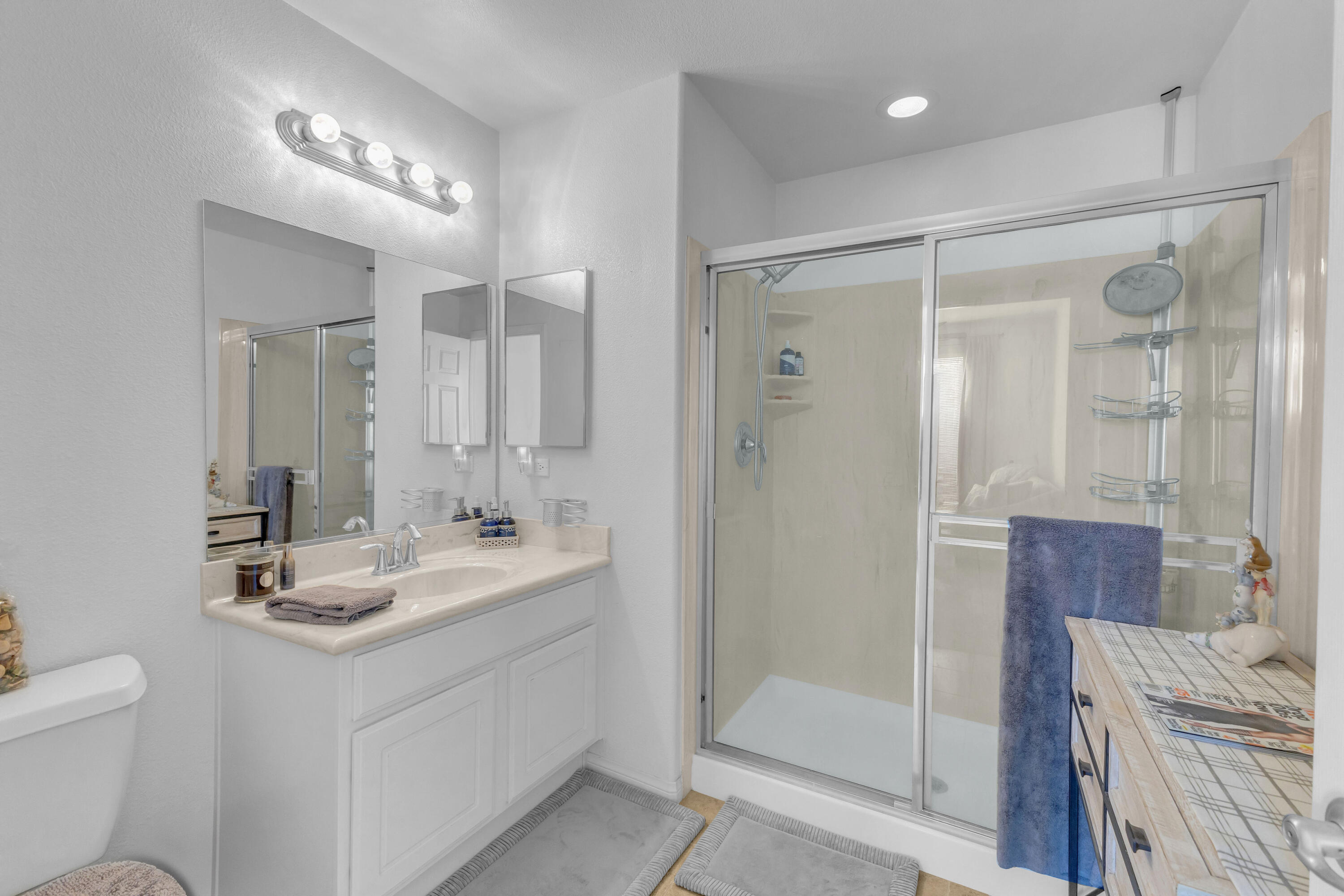 73268 Azure Rain, Unit 102 Palm Desert, CA 92211 - Photo 6 of 44 a bathroom with a sink a toilet and shower