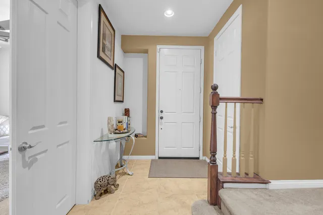 a view of a hallway with entryway wooden floor and front door