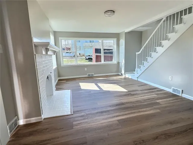 a view of an entryway with wooden floor and a window
